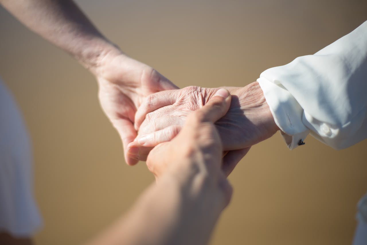 our-services-1 Gentle close-up of intergenerational hands holding, symbolizing connection and care.